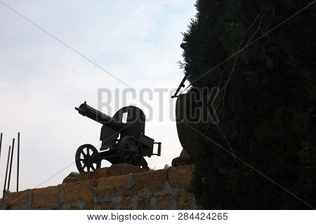 Black Silhouette Of Maxim Machinegun On Brick Pedestal