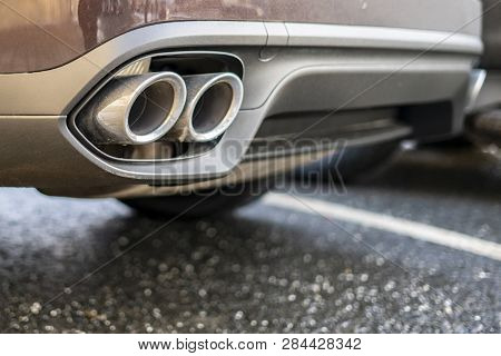 Close Up Exaust Pipe Of A Car Releasing Gas