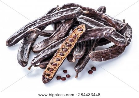 Carob pods and carob powder isolated on the white background.