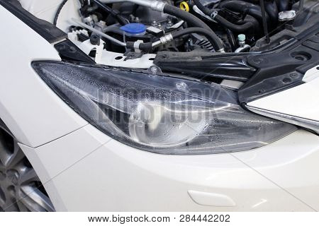 Macro View Of Modern Automobile In Autoservice With Auto Projector Lens. Mechanic Car Repair Service