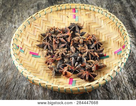 Chinese Star Anise Spice Fruit On Bamboo Basket On Old Wood Background - Other Names Star Aniseed , 
