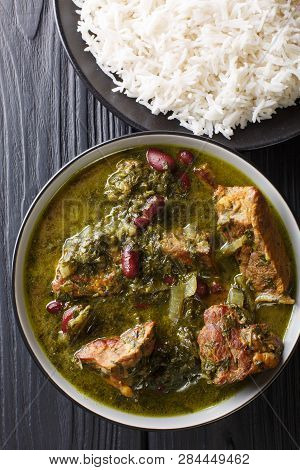 Persian National Food Meat Stew With Herbs And Beans Close-up In A Bowl Served With Steam Rice. Vert