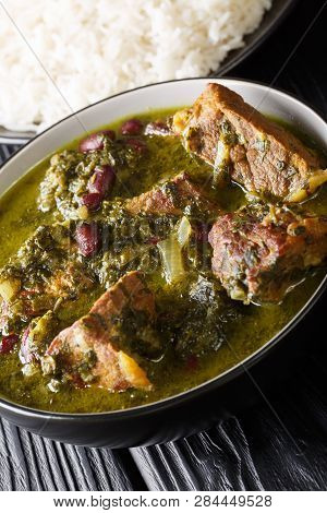 Persian National Food Meat Stew With Herbs And Beans Close-up In A Bowl Served With Steam Rice. Vert