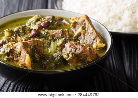 Authentic Ghormeh Sabzi Dish Of Lamb Stew Meat With Herbs And Beans Close-up In A Bowl And Rice. Hor