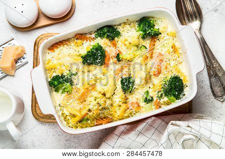 Casserole From Pasta And Vegetables - Carrot, Broccoli And Cauliflower In Cream Sauce With Parmesan.