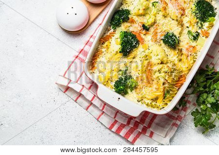 Casserole From Pasta And Vegetables - Carrot, Broccoli And Cauliflower In Cream Sauce With Parmesan.