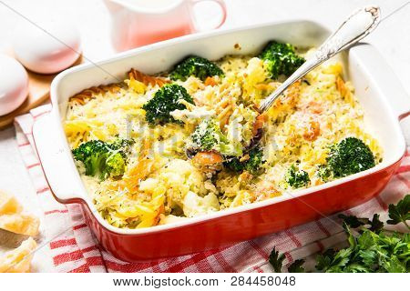 Casserole From Pasta And Vegetables - Carrot, Broccoli And Cauliflower In Cream Sauce With Parmesan.