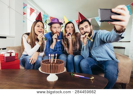 Young Group Of Happy Friends Celebrating Birthday At Home Make Selfie Photo.