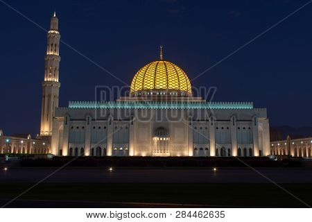 Sultan Qaboos Grand Mosque, Muscat, Oman During The Early Evening Hours In The Dark Blue Sky Of Suns