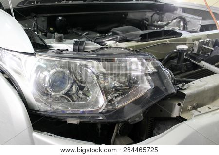 Macro View Of Modern Automobile In Autoservice With Auto Projector Lens. Mechanic Car Repair Service