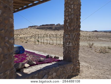 Bed Under A Canopy For Rest In The Shade In The Desert Near The Ancient Fortress Of Khorezm. Uzbekis