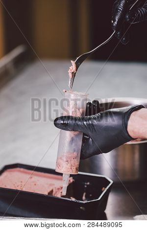 Theme Cooking. Hands Close Up. Young Caucasian Man In Black Uniform And Latex Gloves In Kitchen. Res