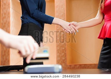 Hand Swiping Debit Card On Pos Terminal.