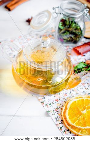 Tea Pot With Ho Greent Tea, Cup Of  Tea  With Mint,  Lemon Slice, Dry Fruits Roll And Tea Mint Leave