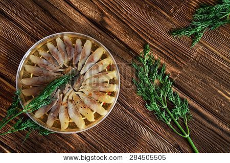 Slices Of Scandinavian Herring Fillet With Spices And Dill In A Transparent Jar. Table Setting On A 