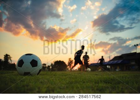 Silhouette Action Sport Outdoors Of A Group Of Kids Having Fun Playing Soccer Football For Exercise 