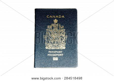 A Canadian Passport On Isolated White Background