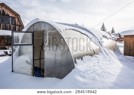 Snow-swept Greenhouse Made Of Polycarbonate In The Country. Berdsk, Novosibirsk Region, Western Sibe