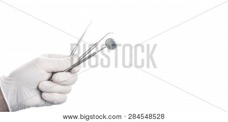 Dental Mirror And Instruments In Doctors Hand With Rubber Glove Isolated On White Background With Fr
