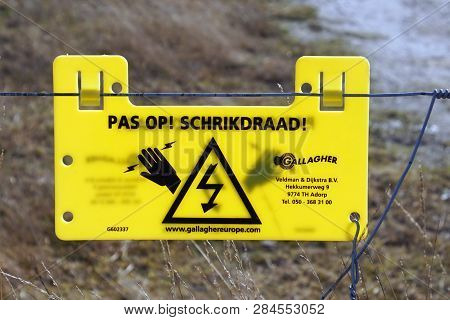 Mierlo, The Netherlands - February 16, 2019: Yellow Dutch Warning Sign For A Electric Fence.