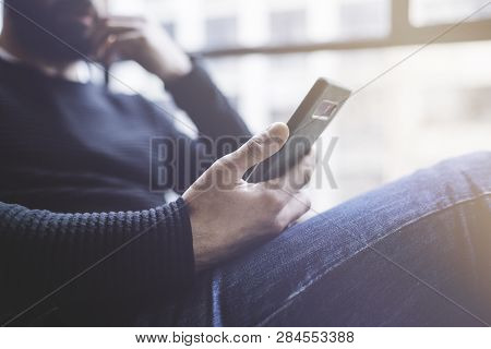 Bearded Hispanic Man In Black Pullover Using Mobile Phone Application For Mobile Blog. Confident You