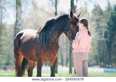 Young Teenage Girl Standing With Her Favorite Brown Horse. Colored Outdoors Horizontal Springtime Im