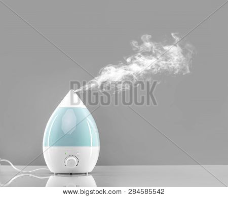 White-blue Air Humidifier. The Unique Design Quickly And Effectively Eliminates Dry Air, Providing A