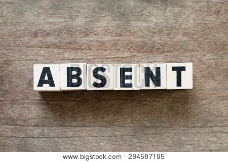 Letter Block In Word Absent On Wood Background
