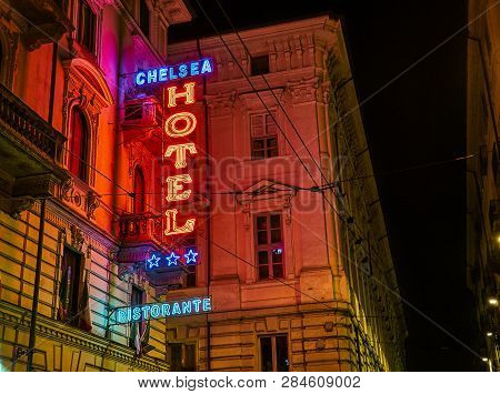 Turin, Italy - January 1, 2019. Hotel And Ristorante Neon Signboard In An Italian Street At Night. T