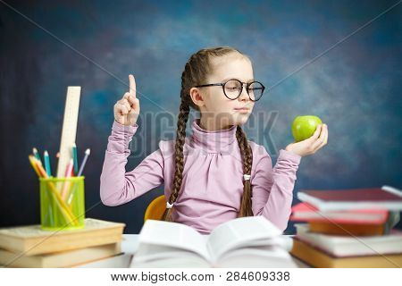 Pretty Primary Student Girl Get Idea Do Homework. Happy Smart Little Learner With Braid Think Questi