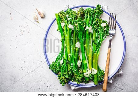 Boiled Broccolini With Garlic On A White Plate. Plant Based Food Concept.