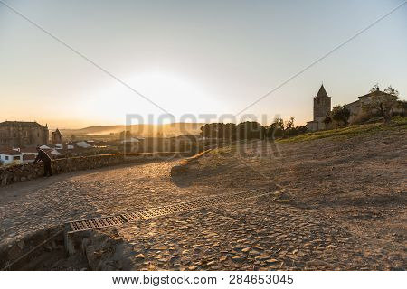Medellin, Extremadura, Spain - February 13, 2019: An Older Man Contemplates The Sunset Over The Vill
