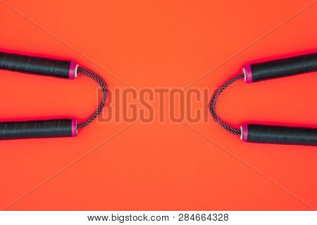Two Nunchats On A Red Background, Flat Lay. Nunchaku For Training