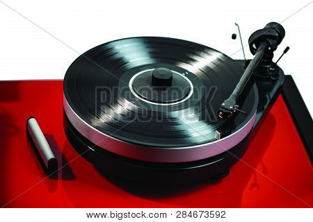 Close Up View Of Audio Record Player With Black Vinyl Disk On Red Surface Isolated. Beautiful Backgr