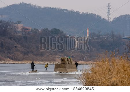 Pocheon, South Korea; February 2, 2019; Family Enjoying Winter Activities On Ice Of Frozen River Dur