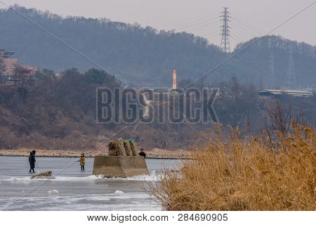 Pocheon, South Korea; February 2, 2019; Family Enjoying Winter Activities On Ice Of Frozen River Dur