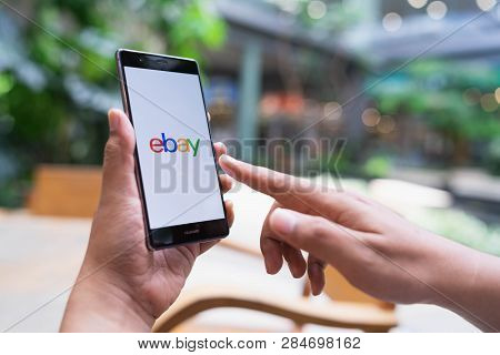 Chiang Mai, Thailand - May 05,2018: Man Holding Huawei With Ebay Apps On The Screen. Ebay Is One Of 