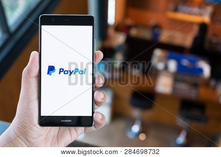 Chiang Mai, Thailand - April 21,2018: Man Holding Huawei With Paypal Apps On The Screen. Paypal Is A