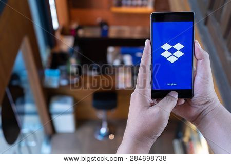 Chiang Mai, Thailand - April 21,2018: Man Holding Huawei With Dropbox On Screen. Dropbox Is A Servic