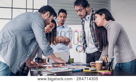 Creative Director Team Lead Standing Brainstrom Branding Project With Designer Team At Meeting Table