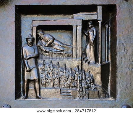 ZURICH, SWITZERLAND - JUNE 23, 2018: Do not let it be you - Naboth's vineyard, relief on the door of the Grossmunster (