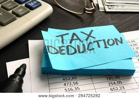 Tax Deduction Written On A Piece Of Paper.