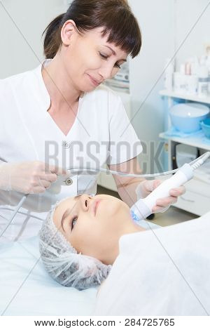 Facial Micro Current Cosmetology Procedure. Beauty Technology Treatment. Woman Face Therapy.