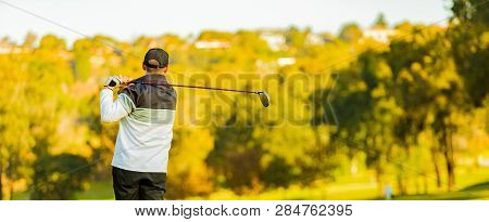 Man Teeing Off On A Golf Course Tee With A Driver Club