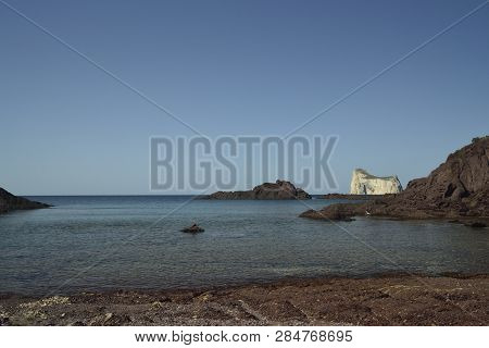 The Beach Of Porto Corallo, In Background The Pan Di Zucchero
