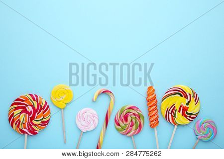 Sweet Colorful Lollipops On A Blue Background