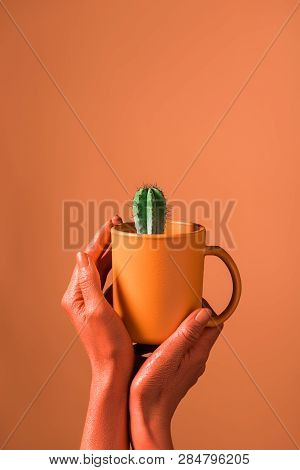 Partial View Of Woman Holding Coral Coffee Cup With Green Cactus On Coral Background, Color Of 2019 