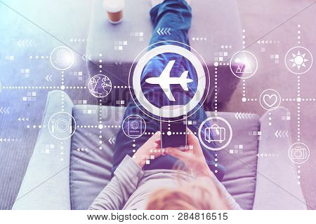 Airplane Travel Theme With Man Using A Smartphone In A Modern Gray Chair