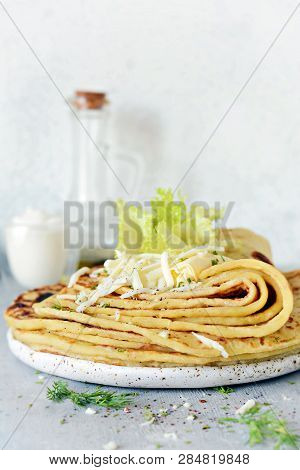 Norwegian Potato Pancakes Lefse On A Light Background With Cheese And Greens. Traditional Scandinavi