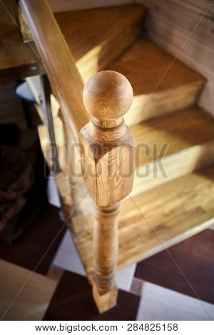 Elements Of Wood Stairs. Round Balusters Inside Cosiness Wooden Eco Room Close-up Over Shiny Tiled F